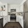 Kitchen with tile backsplash, stainless steel appliances,  and vinyl plank flooring