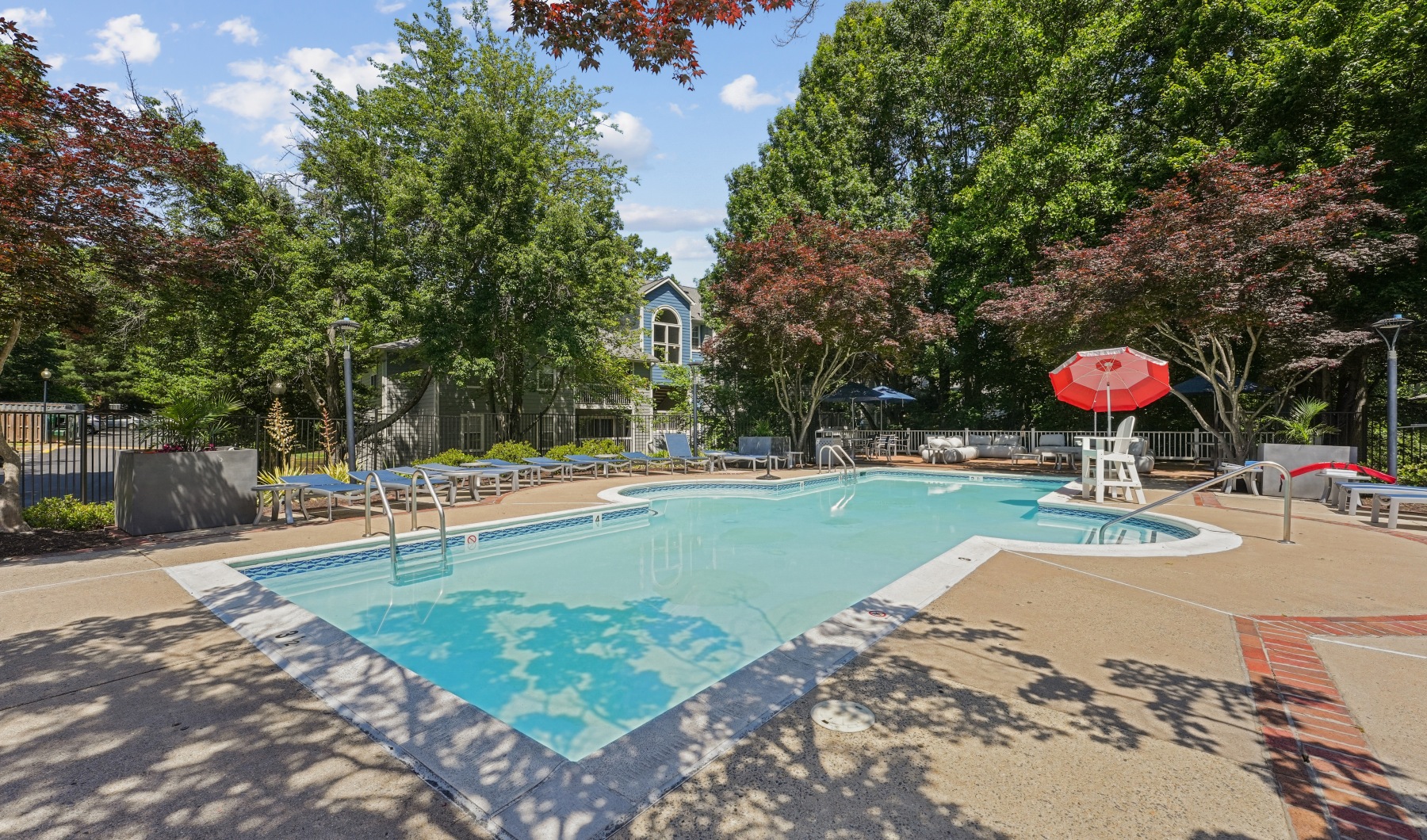 Resort-style swimming pool with lounge seating Resort-style swimming pool with lounge seating
