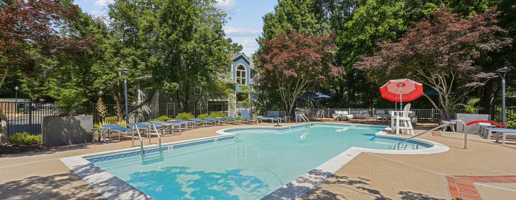 Resort-style swimming pool with lounge seating