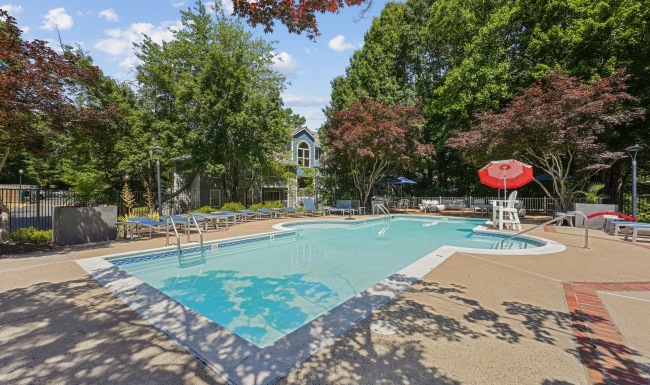 Resort-style swimming pool with lounge seating